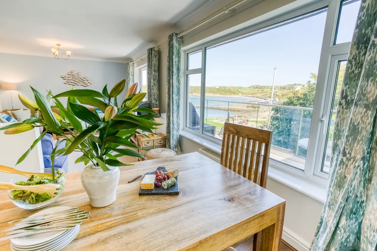 Dining table at Min-Y-Wygyr with harbour views through the window