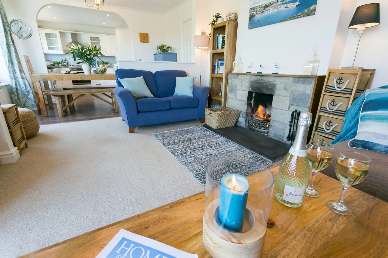 Cosy living area at Min-Y-Wygyr with fireplace and coastal styling